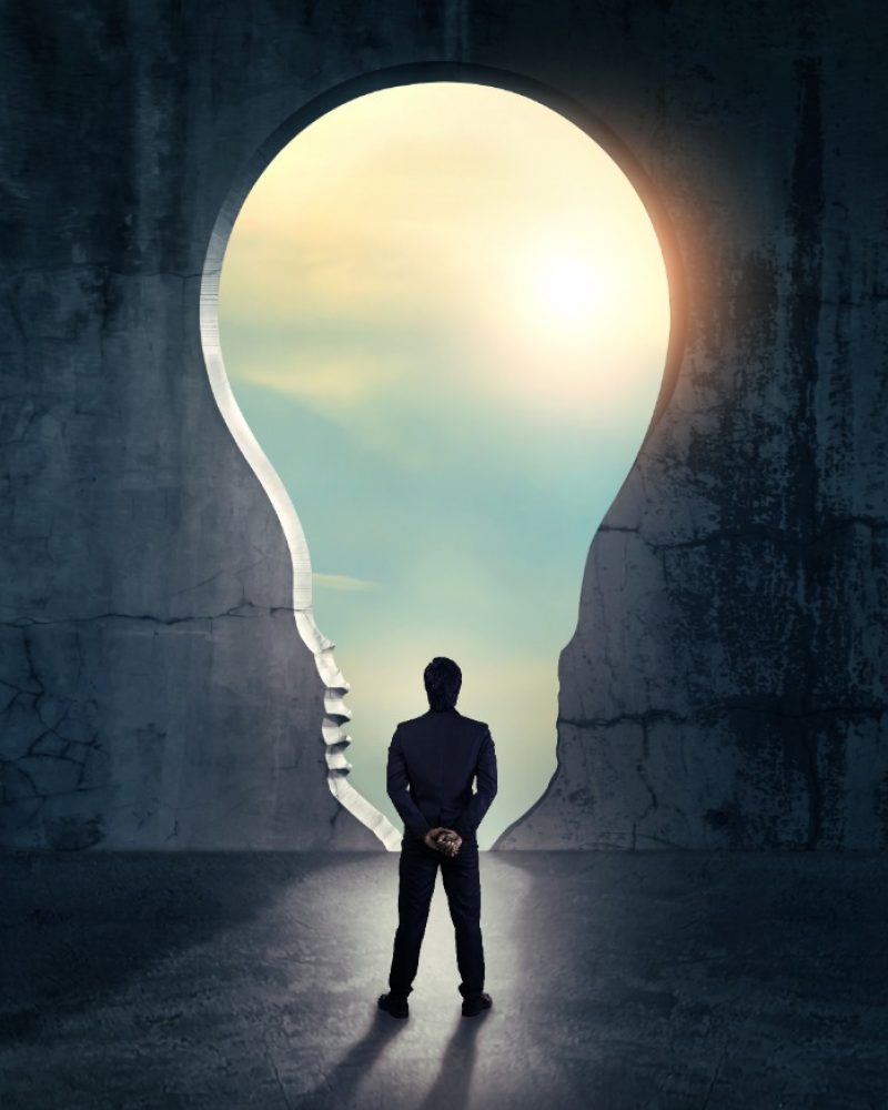 person standing with idea bulb thinking about best it outsourcing company in canada