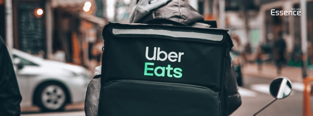 person driving to deliver food with uber eats bag