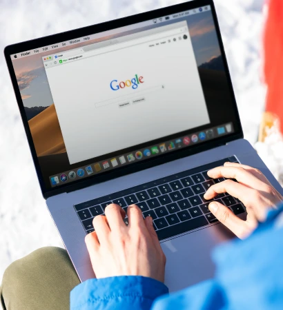 Person typing on a laptop with Google open, representing expert digital strategies by a leading SEO agency in Toronto to boost online visibility and drive organic traffic.